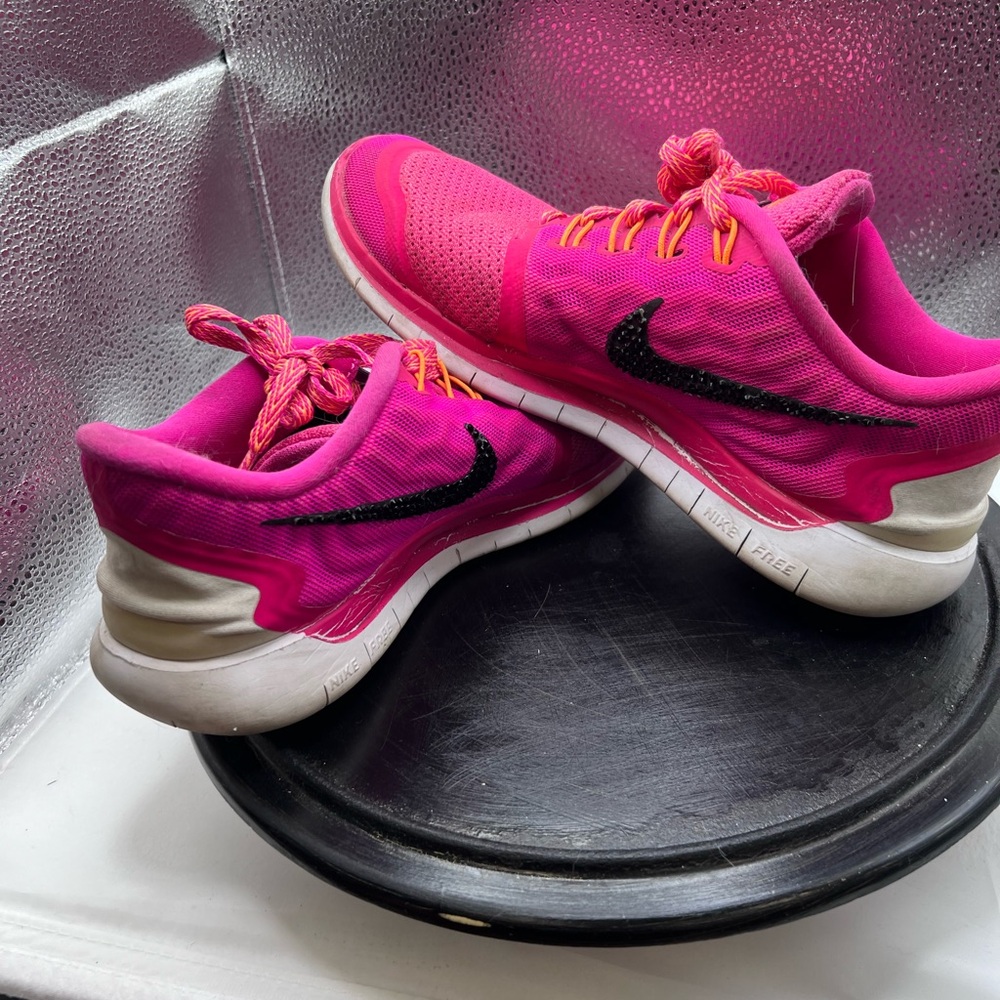 Hot pink Nike running shoes with added black bling